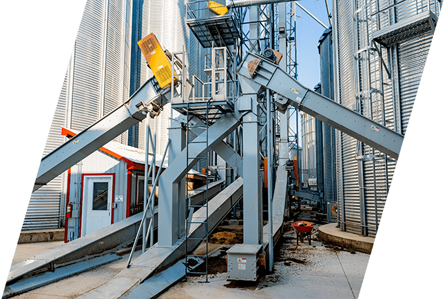 Grain material handling system with conveyors and storage bins